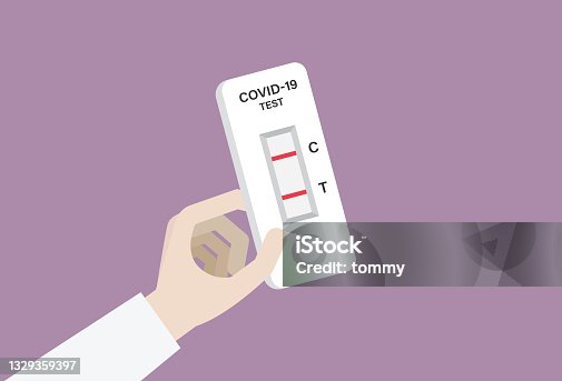 istock Hand holding a COVID-19 rapid test with a positive result 1329359397