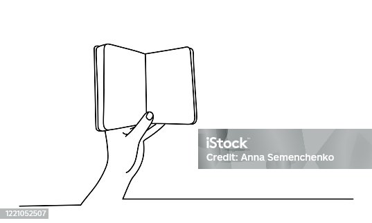 istock Hand holding an open book 1221052507