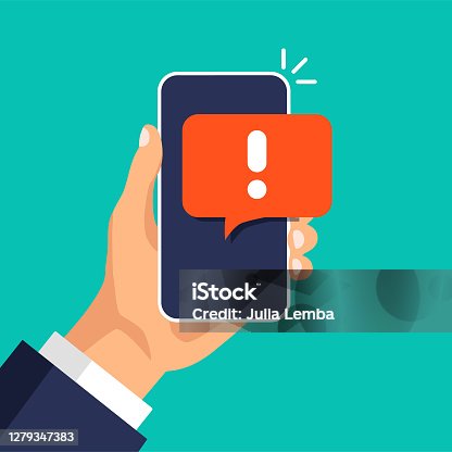 istock Hand holds smartphone with speech bubble and exclamation point icon. 1279347383