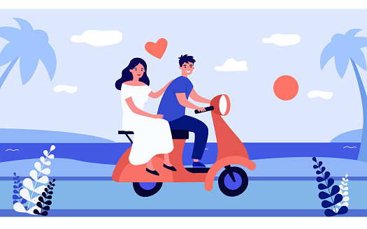 Happy couple riding motorbike along seaside