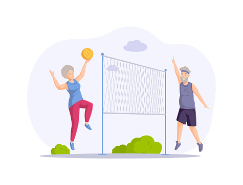 Happy elderly couple playing volleyball at summer park hitting to ball enjoying healthy lifestyle