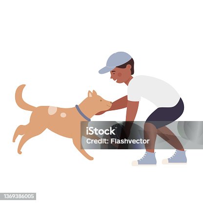 istock Happy little boy playing ball with his lovely puppy 1369386005