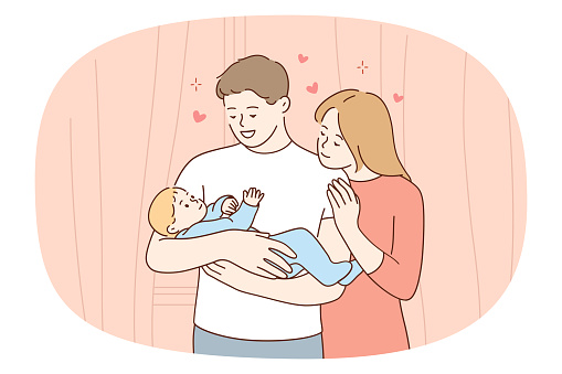 Happy loving young family holding newborn baby