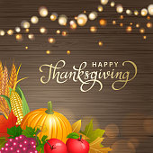Celebrate and gather together at the party of Thanksgiving Day with pumpkin, grape, apple corn, whole wheat and autumn leaves on the background of light shining in the wood pattern