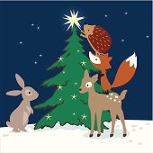 Vector illustration of forest animals decorating a Christmas tree on a winter night.