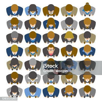 istock High angle view of businessman looking up and standing in large group of business people 1283221283