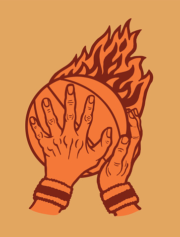 Human hands holding basketball with flames