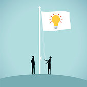Two people raise a flag to advertise their good idea