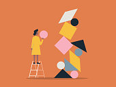 istock Illustration of person building with balanced shape blocks 1322012019