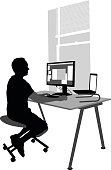 A vector silhouette illustration of a man sitting at his computer work station.