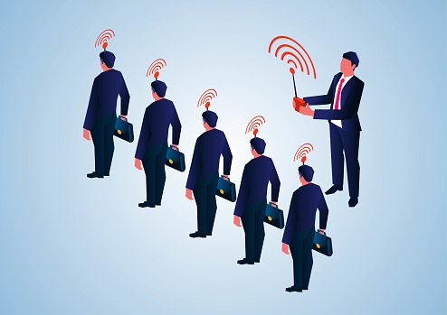 Isometric manager holding a remote control a row of businessmen within signal range