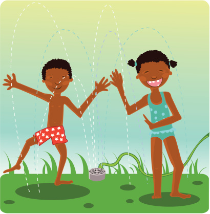kids playing in a sprinkler