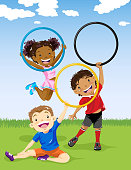 Kids playing plastic hoop outdoors.