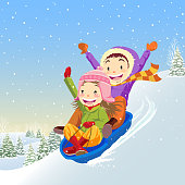 Two kids sledding in winter.