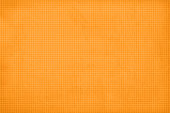 istock Light golden brown or peach gradient coloured textured effect horizontal grunge waffle like halftone pattern old vector backgrounds with an all over pattern of narrow subtle checkered lines 1352179635