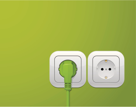 Lime green wall with a power outlet plug