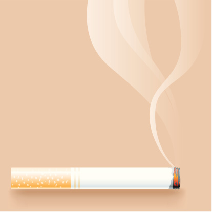 A lit cigarette with smoke on a beige background