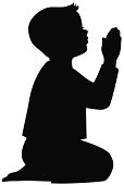 Little boy kneeling in his pajamas and praying. Vector silhouette illustration.