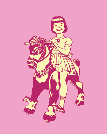 Little girl riding toy pony on wheels