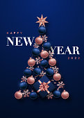 Luxurious abstract Christmas tree in the form of New Year decorations. Realistic rose gold and blue 3d baubles, snowflakes, star and gift box. Template for vertical banner, website advertising, party invitation, social media.