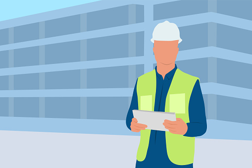 Male Engineer Wearing Hardhat Standing In Front Of The Building Construction