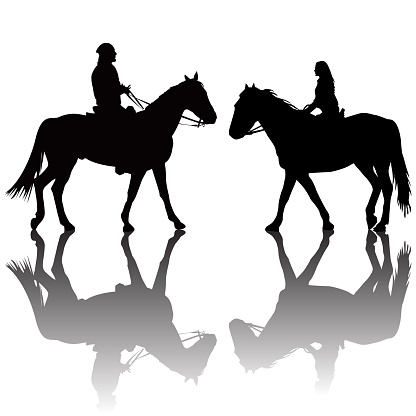 Man and woman riding horses silhouettes with shadows