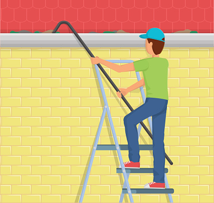 Man Cleaning rain gutter on a ladder