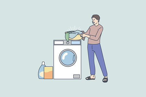 Man do laundry use washing machine at home