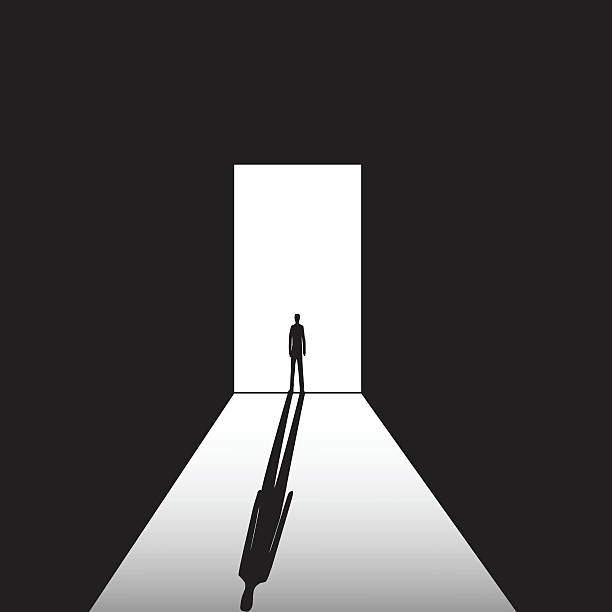 man in the doorway man standing on the bright and the dark background in the doorway with shadow door silhouettes stock illustrations