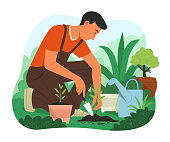 istock Man Planting a Tree in Garden. 1369215974