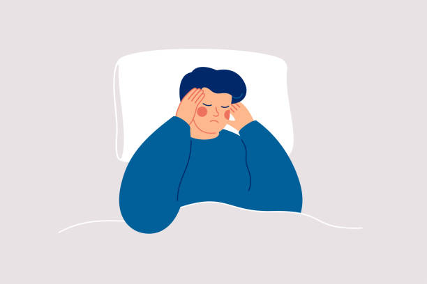 Man suffers from insomnia and had difficulty falling asleep. Boy has headaches during nighttime. Sleepy male lying on bed and touching his temple. Insomnia and trouble sleeping disorder. vector art illustration