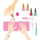 Female hands getting professional manicure.