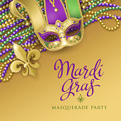 An invitation to the masquerade party for the Mardi Gras with jester mask, metallic fleur de lis and colorful beads on the gold colored background