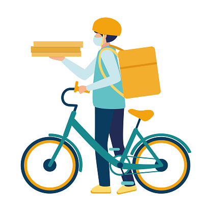 A medical masked courier delivers food on a bicycle during the Covid19 coronavirus virus epidemic. Deliveryman with a parcel box on the back and pizza boxes in hand. Boy with food delivery service.