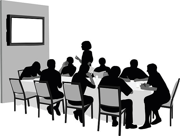 Meeting With Audio Visual Presentation A vector silhouette illustration of a business meeting in a conference room with business men and women sitting around a table with a monitor on the wall in the background.  A young woman stands and speaks. office silhouettes stock illustrations