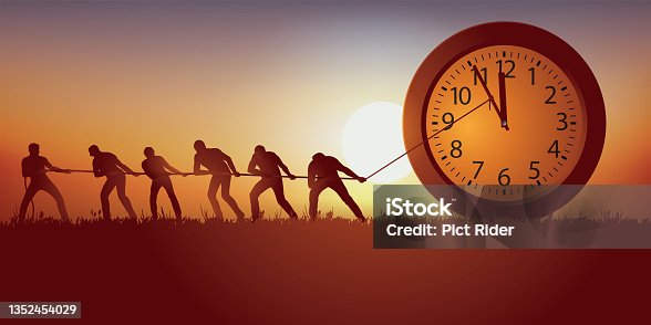 istock Men try to hold back the passage of time by blocking the hands of a clock with a rope. 1352454029