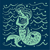 istock Mermaid Hugging Her Pet Fish 1211861613