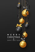 Merry Christmas and Happy New Year. Background hanging gold and black balls with ribbon and bow. Xmas greeting card with decorative bauble