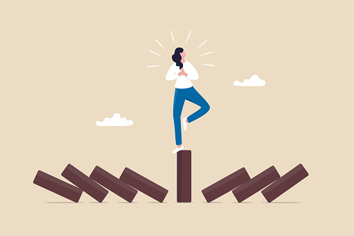 Mindfulness meditation relax to reduce stress and eliminate distraction, calm to build energy or spiritual wellness concept, success woman relax and meditating with yoga pose on standing domino.