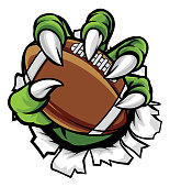 A monster or animal claw holding an American football ball and breaking through the background