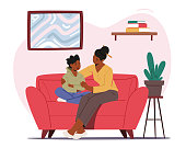 istock Mother Comforting Child Sitting on Sofa in Living Room. Mom and Son Talking of Problems, Parent Support and Embrace Boy 1303392992