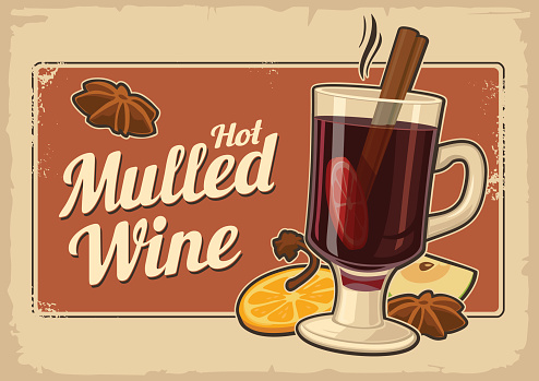 Mulled wine with glass of drink and ingredients.