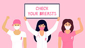 National Breast Cancer Awareness Month. A doctor in a protective mask holds a poster. Girl was wearing a head scarf after chemotherapy and with a pink ribbon on T-shirt raised fist up