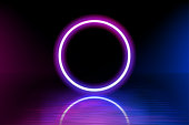 Neon color geometric circle on a dark background. Round mystical portal, luminous line, neon sign. Reflection of blue and pink neon light on the floor. Rays of light in the dark. Vector. EPS 10