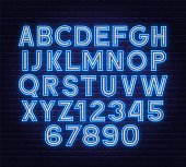 Neon two tone font blue white on brick wall background.