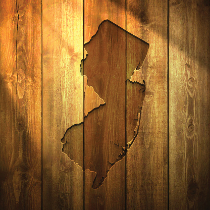 New Jersey Map on lit Wooden Background