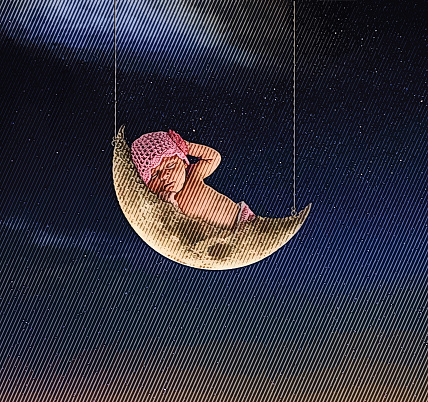 Newborn baby girl sleeping on the moon