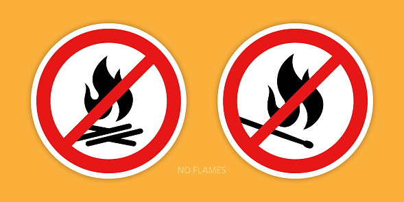 No flames signs. Two prohibition signs with a burning match and campfire symbols are isolated on an orange background. Vector illustration.