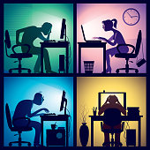 Man and woman sitting in front of screens in a dark office room.