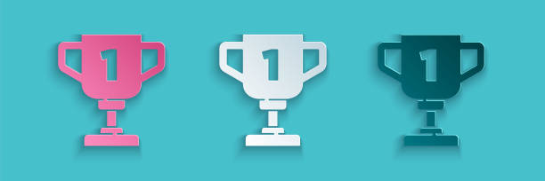 Paper cut Award cup icon isolated on blue background. Winner trophy symbol. Championship or competition trophy. Sports achievement sign. Paper art style. Vector Paper cut Award cup icon isolated on blue background. Winner trophy symbol. Championship or competition trophy. Sports achievement sign. Paper art style. Vector. pink soccer balls stock illustrations